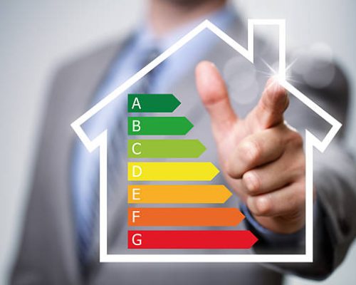 Businessman pointing to energy efficiency rating chart and house icon concept for performance, efficiency and environmental conservation